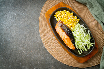 grilled salmon fillet steak on hot plate