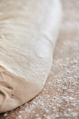 The process of making wheat bread at home. Dough division. The concept of healthy homemade food. Vertical photo.