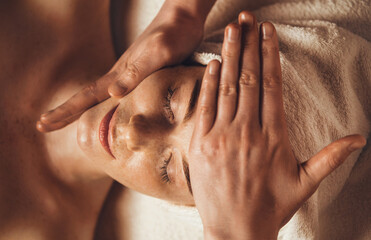 Beautiful woman in spa salon getting face massage treatment. Girl facial treatment. Skin care. Body...