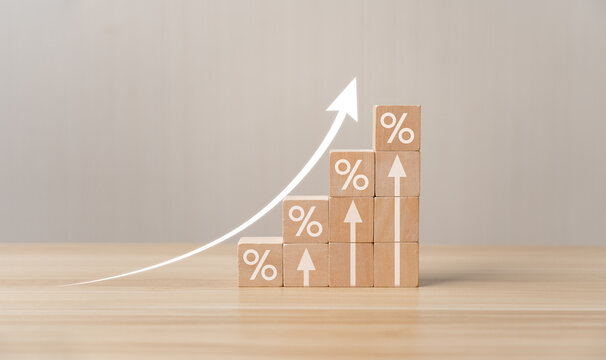 Interest rate financial and mortgage rates concept. Wooden blocks with Icon percentage symbol and arrow pointing up. company business growth and sales, interest rate, tax, real estate