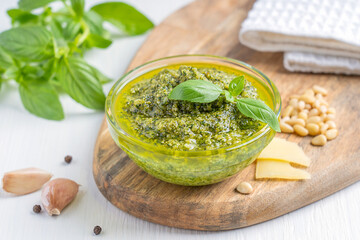 Homemade traditional italian herbal peso sauce made of blended green basil leaves, pine nuts,...