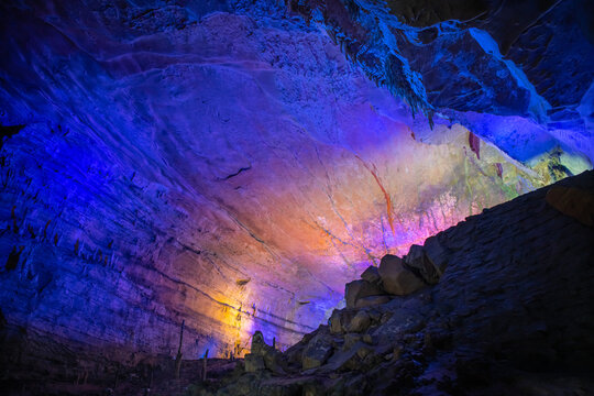 Blue, purple, pink and orange lighting of the Huanglong cave, Zhangjiajie, Hunan, China. Horizontal image with copy space for text, background