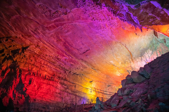 Pink, yellow and orange lighting of the Huanglong cave, Zhangjiajie, Hunan, China. Horizontal image with copy space for text, background