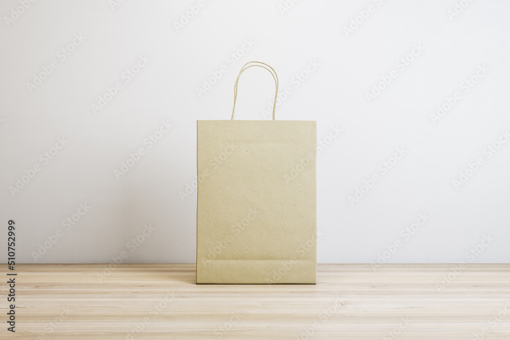 Poster blank paper shopping bags on white concrete and wooden surface background with mock up place. purcha