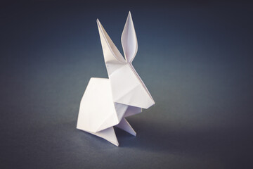 White paper rabbit origami isolated on a grey background - obrazy, fototapety, plakaty