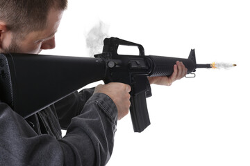 Man shooting from assault rifle on white background, closeup