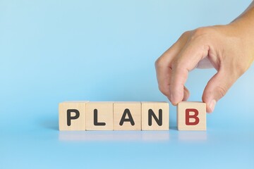 Plan B or backup and contingency plan in business concept. Wooden blocks in blue background. 