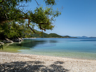 Fototapeta na wymiar A pristine beach with crystal clear calm water on Ithaca Island, Greece.