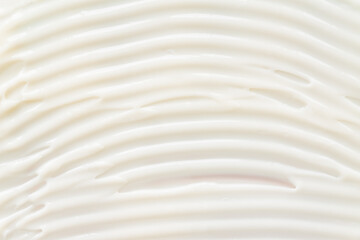 Close-up texture of white moisturizing cream. Skin care product background. Sun protection or liquid foundation.