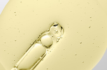 The texture of a cosmetic serum with a pipette closeup. Macrophotography