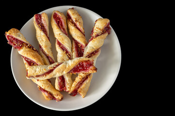sugar-free rolls with raspberry jam on a black background