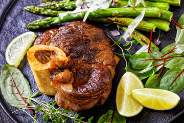 braised osso buco with grilled asparagus, top view
