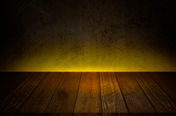 Old wood table with dark Concrete wall and Yellow lighting Effect background.