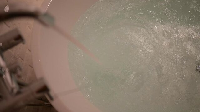slow motion scene, water flowing in bathtub