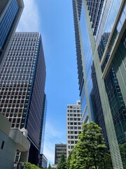 Naklejka premium Modern office buildings at Tokyo Marunouchi corporate district, sunny weekday year 2022 June 13th, Japan