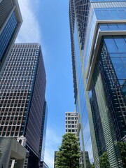 Naklejka premium Modern office buildings at Tokyo Marunouchi corporate district, sunny weekday year 2022 June 13th, Japan