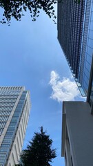 Fototapeta premium Modern office buildings at Tokyo Marunouchi corporate district, sunny weekday year 2022 June 13th, Japan