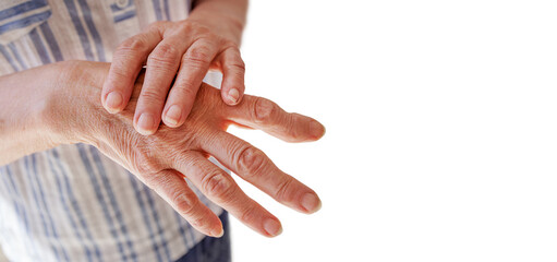 old woman with arthritis makes massage, close-up of a hand on a white background