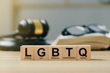 Concept of  Lgbt rights and law. wooden blocks with Text LGBTQ on Judge gavel background. symbol of...