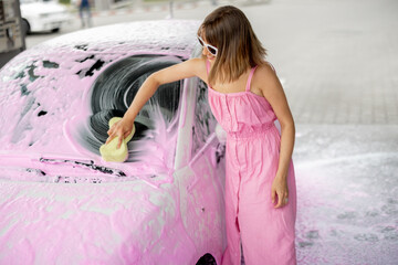 Woman washing her car at self-service car wash