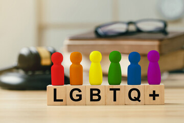 Concept of  Lgbt rights and law. wooden blocks with Text LGBTQ+ on Judge gavel background. symbol...