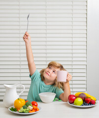 Little child boy having healthy breakfast. Kids nutrition and development. Eating vegetables by child make them healthier.