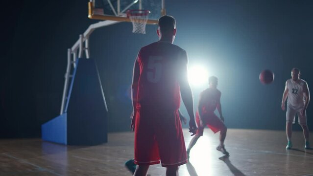 International basketball game, the confrontation between two teams, sporty lifestyle, mens active game at night time, cinematic light, 4k slow motion.