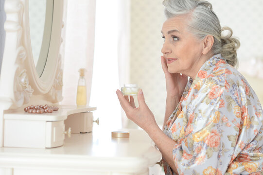 Beautiful Senior Woman Doing Makeup At Home