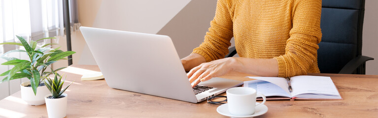 Cropped image professional business woman working in her office via laptop, young female manager using laptop computer device while sitting in Modern Loft, Flare Light, Concept Process Concept