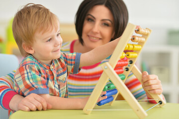 Young mother with cute little son learning