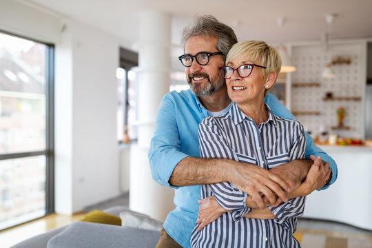 Portrait of happy senior couple in love spending time together at home