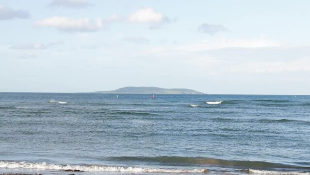 Malahide beach on a sunny day with the Lambay Island in the distance, Ireland