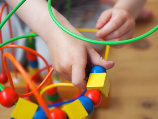 A bright educational toy for the youngest baby. Wooden eco-friendly game for children. Labyrinth developing fine motor skills for kids.