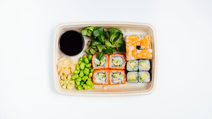 Fresh sushi set box on white background, sustainable and eco-friendly sushi take out containers. Asian food