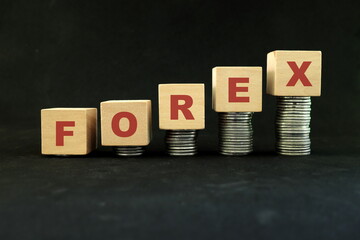 Forex or foreign exchange trading market growth, profitability and investment concept. Increasing stack of coins in wooden blocks.