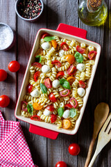 Fusilli pasta with mozzarella, tomatoes and basil. Italian food. Healthy eating. Vegetarian food.