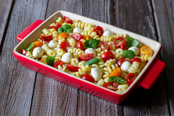 Fusilli pasta with mozzarella, tomatoes and basil. Italian food. Healthy eating. Vegetarian food.