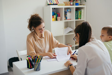 boy having conversation with psychologist for enrollment in school - obrazy, fototapety, plakaty