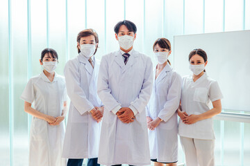 病院で働くマスクをした医療従事者の男女（医者・看護師）
