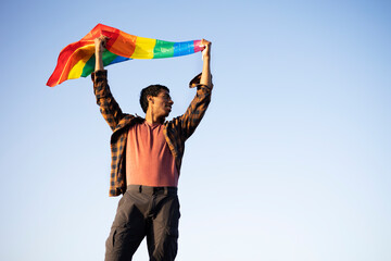 Fototapeta na wymiar Happy man with a pride flag. LGBT community..