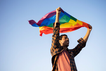 Happy man with a pride flag. LGBT community..