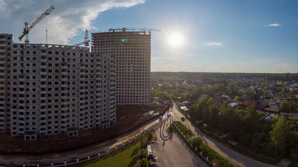 construction of a skyscraper on clera sky with sun background