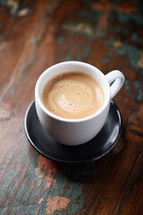 Cup of coffee on wooden background. Close up.                                                                                            