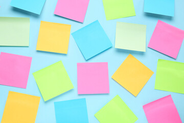 Blank colorful sticky notes on turquoise background, flat lay. Space for text