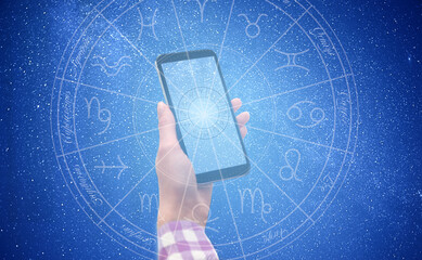 Woman with smartphone reading daily horoscope, closeup