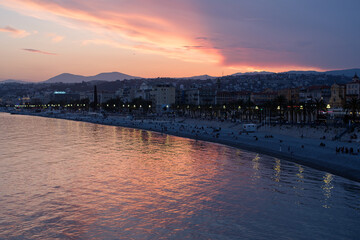 The famous Nice promenade in the evening light with a red sky. 