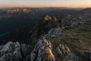 Jagged mountain edge and valley below at golden hour