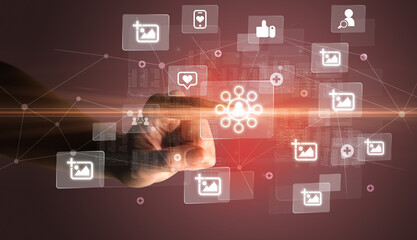Naklejka premium Hand pressing social media multimedia application screen with media icons on futuristic concept