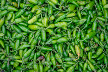 spices: A bunch of spicy green hot chili peppers isolated over white background
