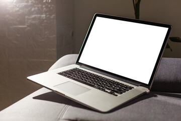 Mockup blank screen laptop in living room. Copy space.